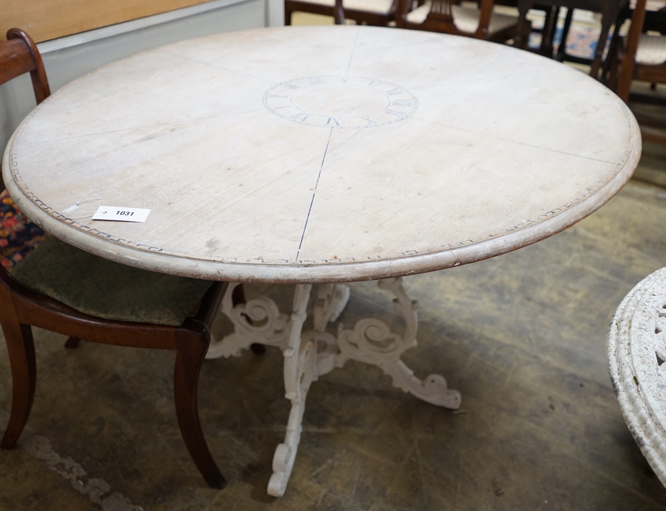 A Victorian style circular painted pine circular dining table on painted cast metal base, diameter 125cm, height 73cm